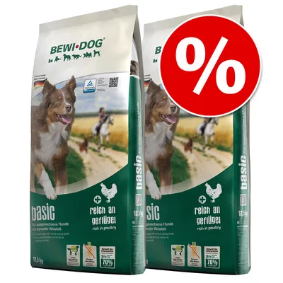 Two bags of BEWI DOG basic rich in poultry dry dog food, 12.5 kg each, with a large red percentage discount symbol on the top right. Visible German and English text on packaging. Two bags of BEWI DOG basic rich in poultry dry dog food, 12.5 kg each, with a large red percentage discount symbol on the top right. Visible German and English text on packaging.