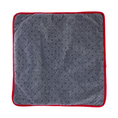 Grey square mat with red edges and fine floral pattern.