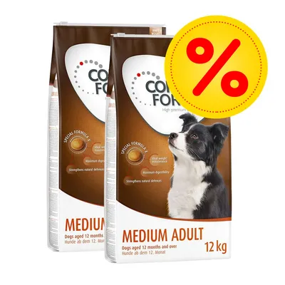 Två säckar hundfoder med texten 'MEDIUM ADULT 12 kg', synlig hundbild och stor gul procent-symbol för rabatt. Text: 'Dogs aged 12 months and over'.