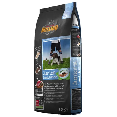 Belcando Junior Lamb & Rice dry dog food, 15kg bag, visible text includes 'holistic', 'Extra Frischfleisch', and feeding info in German. Image of a dog with a person on the front.