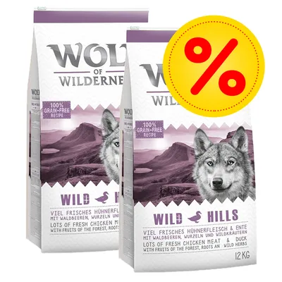 Wolf of Wilderness Wild Hills hondenvoer, 12 kg zakken, 100% grain-free recipe, veel vers kippenvlees en eend, met bosbessen, wortels en wilde kruiden. Aanbiedingssymbool zichtbaar.