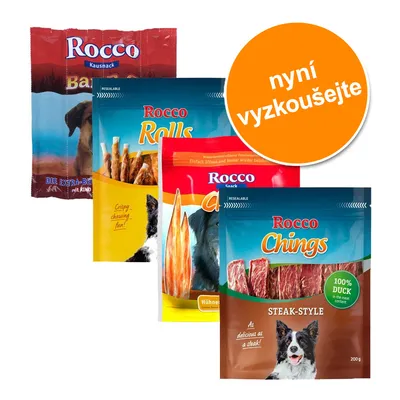 Čtyři balení pamlsků pro psy Rocco: Kausnack, Rolls, Chings Steak-Style 100% Duck, různé příchutě. Oranžový kruh s textem 'nyní vyzkoušejte'. Čtyři balení pamlsků pro psy Rocco: Kausnack, Rolls, Chings Steak-Style 100% Duck, různé příchutě. Oranžový kruh s textem 'nyní vyzkoušejte'.