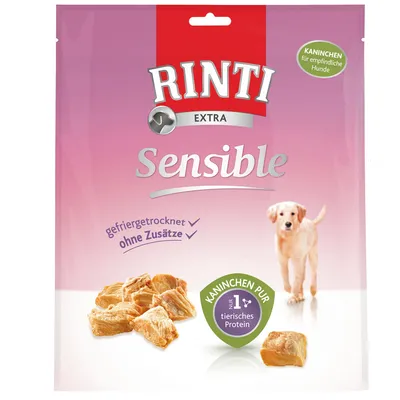 Rinti Extra Sensible, Kaninchen pur, gefriergetrocknet, ohne Zusätze, nur 1 tierisches Protein. Pakiranje s komadićima poslastica i slikom psa. Tekst na njemačkom jeziku.