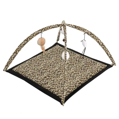 Play mat with leopard pattern and play arch, equipped with hanging toys such as balls and feathers.