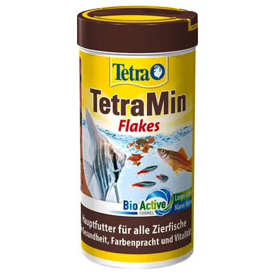 Boîte TetraMin Flakes, alimentation pour poissons d’aquarium, texte visible : BioActive Formel, Langes Leben, Klares Wasser. Texte en allemand sur la santé et vitalité des poissons. Boîte TetraMin Flakes, alimentation pour poissons d’aquarium, texte visible : BioActive Formel, Langes Leben, Klares Wasser. Texte en allemand sur la santé et vitalité des poissons.