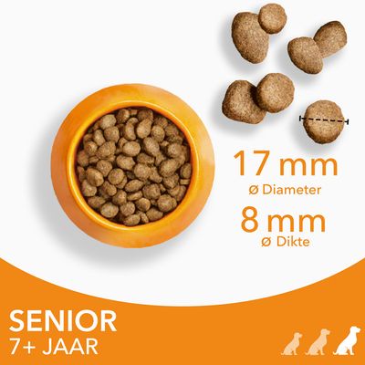 Hondenbrokken in oranje bak, brokjes met diameter 17 mm en dikte 8 mm. Tekst: SENIOR 7+ JAAR.