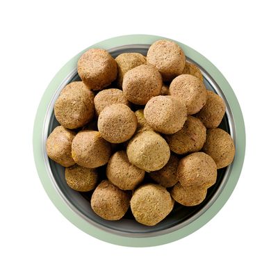 Bowl filled with round, brown dry food pieces displayed from above.