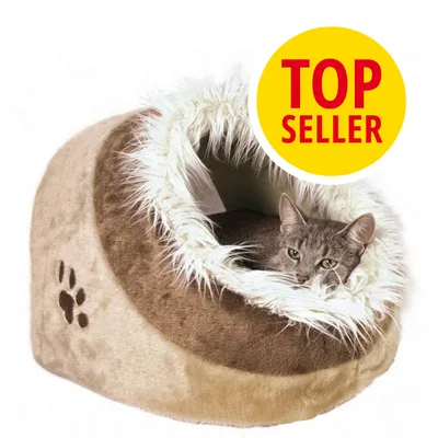 Cueva para gatos de felpa beige con huella marrón, interior forrado de pelo sintético blanco. Gato gris dentro. Círculo amarillo con texto: TOP SELLER.