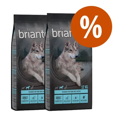 2 sacchi di crocchette Briantos Adult 12 kg con immagine di cane e simbolo percentuale per offerta. Testo visibile: 'ADULT', 'GRAIN-FREE RECIPE', 'SALMON & TROUT', 'MEAT AS PRIMARY'.