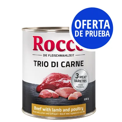 Lata de comida Rocco Trio di Carne, 800 g. Texto visible: '3 meat varieties', 'Beef with lamb and poultry'. Sello azul: 'OFERTA DE PRUEBA'.