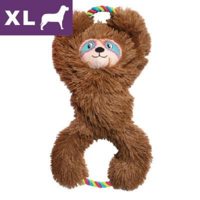 Giocattolo per cani a forma di bradipo in peluche marrone con maniglie in corda colorata, etichetta XL cane visibile in alto a sinistra.