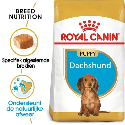 Royal Canin Puppy Dachshund hondenvoer, verpakking met afbeelding van een pup, tekst: 'Specifiek afgestemde brokken' en 'Ondersteunt de natuurlijke afweer'.