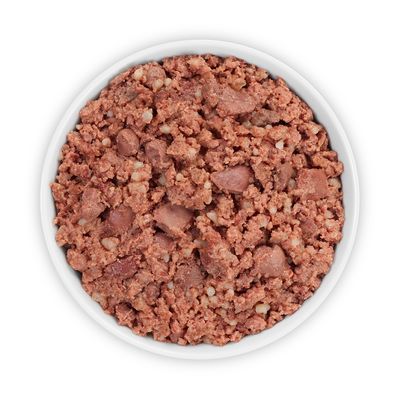 Close-up of red wet food with meat pieces in a white bowl.