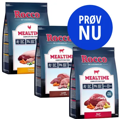Tre poser Rocco Mealtime Complete Dog Food: Chicken, Lamb og Beef. Tekst på blå cirkel: PRØV NU. Synlig tekst: Grain Free Recipe, 70% Animal Ingredients, Rich in Fresh Beef, Full Taste.
