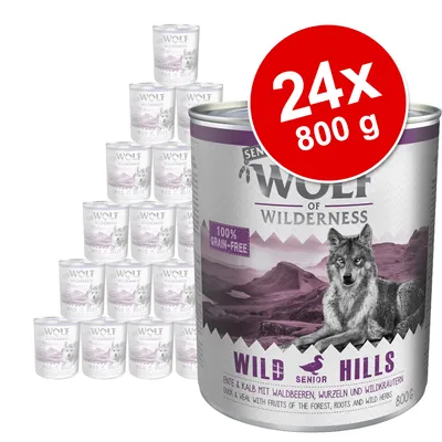 Wolf of Wilderness Wild Hills Senior våtfoder, 24 x 800 g burkar. Text: 100% grain-free. Bild på varg och bergslandskap på förpackningen.
