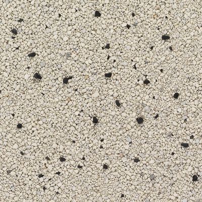 Närbild av vit-beige kattsand med enstaka svarta korn.