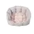 Round, padded pet bed made of grey fabric with soft beige interior surface.