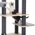 Cat tree with multiple levels, wooden and sisal-wrapped posts, cat playing on the middle level.