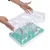 Pet toy with transparent lid removed by hands. Underneath, green base with obstacles and openings.