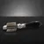 Metal brush with black ergonomic handle and double rows of bristles for coat care.