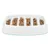 White feeding bowl with multiple vertical compartments, filled with brown dry food pieces.