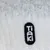 Tiaki. Markenlogo auf weissem, strukturiertem Hintergrund.
