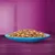 Chunks of wet pet food served on a blue plate, showing texture and portion size.