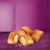 Five filled, flaky pastry-style treats with a creamy centre displayed on a purple surface.