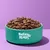 Bowl filled with dry pet food, green bowl labelled BARKING HEADS.