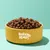 Bowl filled with round brown kibble pieces, showing product appearance and portion size.