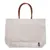 Bolsa de transporte Tiaki de tela blanca con asas marrones, adecuada para transportar objetos.