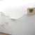 Wall-mounted climbing and play system made of wood with platforms, bridge and cave with cat head cut-out.