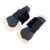 Paire de protections pour jambes de cheval, extérieur noir rigide, intérieur doublé de fourrure synthétique beige, fermeture par deux bandes auto-agrippantes, étiquette visible 'Noble Tales'.