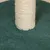 Kratzbaum-Säule aus hellem Sisal auf grünem Filzboden.