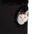 Animal inside a dark cylindrical scratching post with a round entrance, demonstrating use of the product's hideaway feature.