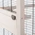 Detailweergave van een kooi met houten frame, metalen traliewanden en zwart sluitsysteem.