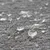 Gros plan sur des gouttes d’eau posées sur une surface textile grise, montrant la texture du tissu et l’effet perlant de l’eau.