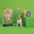 Selection of Lily's Kitchen Organic pet food and treats displayed with a dog, showing product packaging for Chicken Bake, training treats, bedtime biscuits, and assorted organic trays.