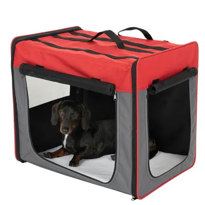 Chien allongé dans une caisse de transport en tissu rouge et gris avec fenêtres en maille, poignées sur le dessus et ouvertures latérales.