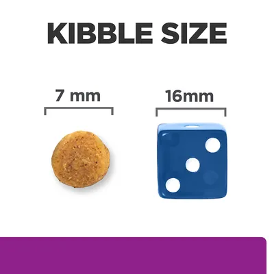 Kibble size comparison showing a 7 mm round kibble next to a 16 mm blue dice for scale.