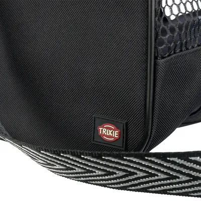 Sac noir en tissu avec sangle à motif et maille, étiquette visible : TRIXIE