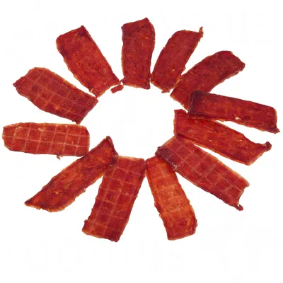 Red, rectangular meat strips arranged in a circular pattern. Texture with visible grill marks.