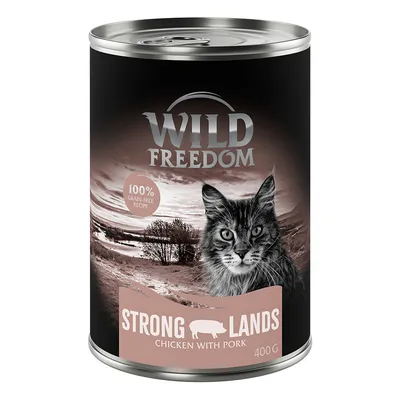 Lata de 400 g de Wild Freedom Strong Lands, receta de pollo con cerdo. Texto visible: 100% grain-free recipe. Imagen de un gato en el envase.
