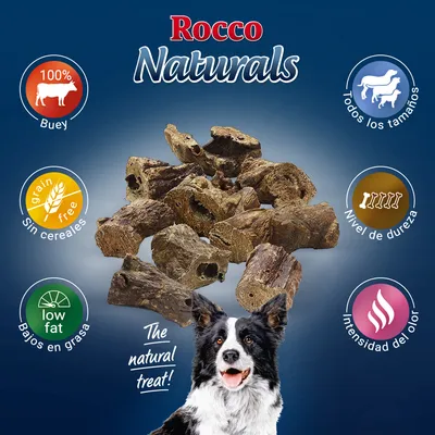 Rocco Naturals, 100% buey, sin cereales, bajos en grasa. Para todos los tamaños. Nivel de dureza e intensidad del olor indicados. Snack natural para perros visible en el centro.