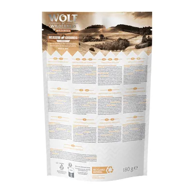 Wolf of Wilderness Wild Bites Meadow Grounds verpakking, 180 g. Meertalige productinformatie en recyclebaar materiaal symbool zichtbaar.