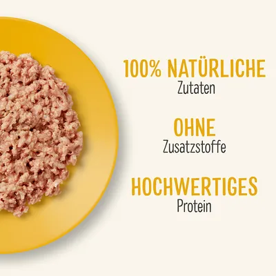 Mleta hrana na rumenem krožniku. Besedilo v nemščini: 100% NATÜRLICHE Zutaten, OHNE Zusatzstoffe, HOCHWERTIGES Protein.