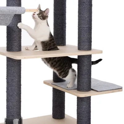 Cat tree with multiple levels, wooden and sisal-wrapped posts, cat playing on the middle level.