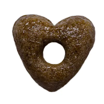 Едно парче суха храна за домашни любимци във формата на сърце с отвор в средата, кафяв цвят.