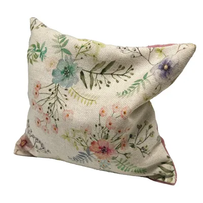 Decorative cushion with floral pattern in pastel colours, including flowers and leaves on beige fabric.