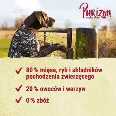 Purizon. 80 % mięsa, ryb i składników pochodzenia zwierzęcego, 20 % owoców i warzyw, 0 % zbóż. Widoczny pies przy ogrodzeniu na tle pola.
